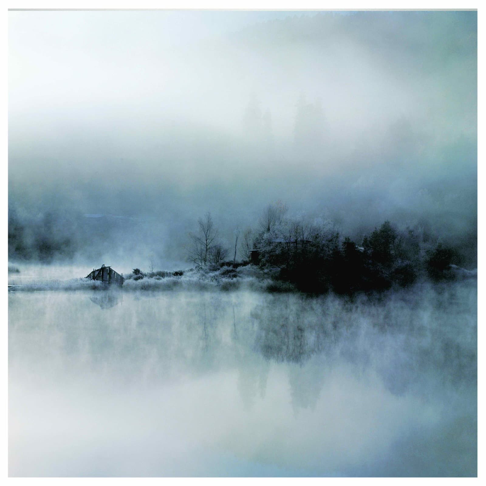 Ethereal misty lake at dawn