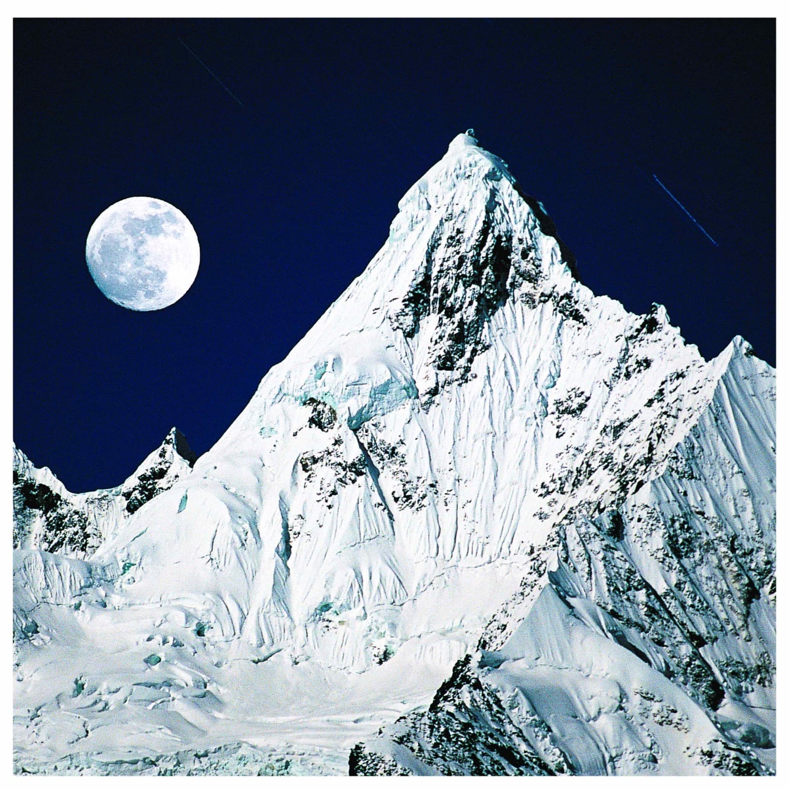 Moon rising over snow peak